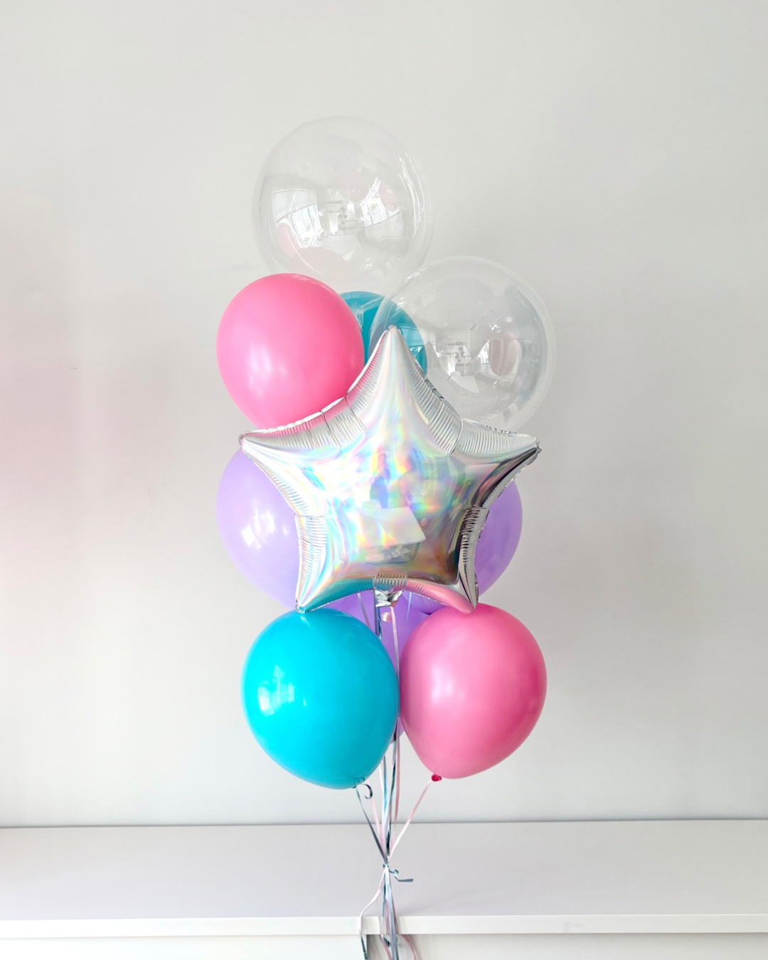 helium bouquet with two bubble balloons, iridescent star, and colourful latex balloons