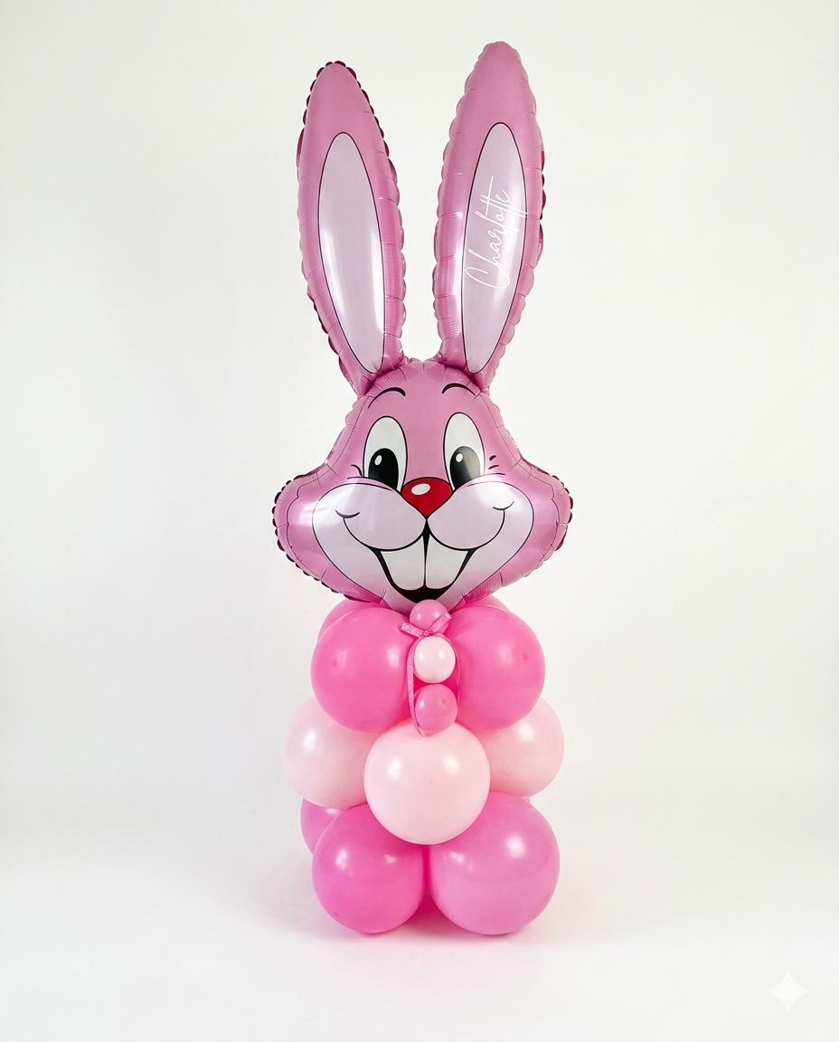 A pink balloon column featuring a jumbo bunny head balloon with a custom text decal, on a white background