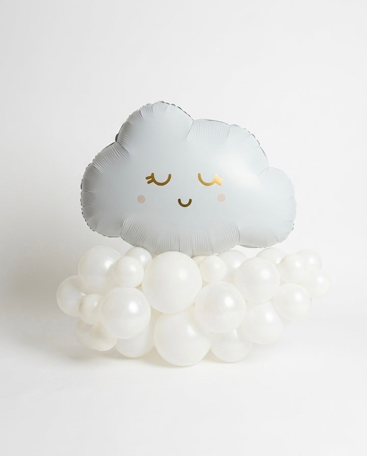 a smiley cloud balloon with pink and metallic gold accents, on white latex balloons arranged in a cloud shape on a white backdrop