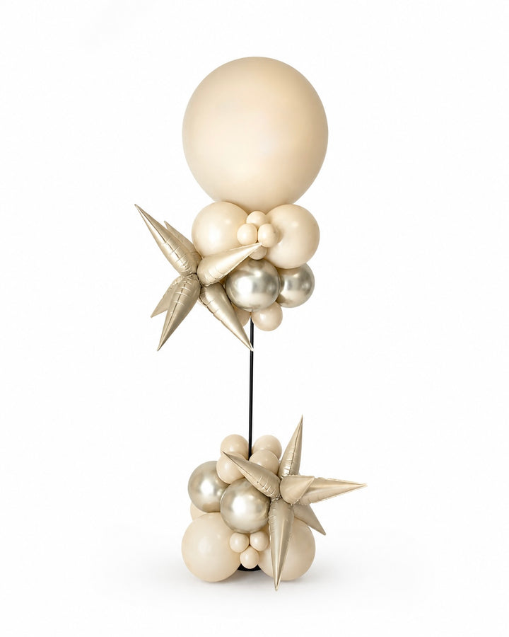balloon column with beige jumbo balloon on top and star-shaped accents on a white background
