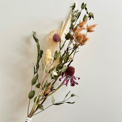 dried flowers tied in a bouquet, different colours