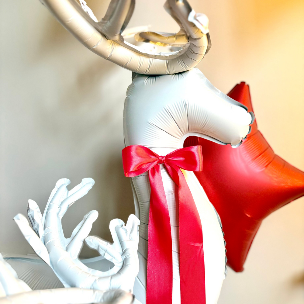 Decorative reindeer balloon with a red satin bow 