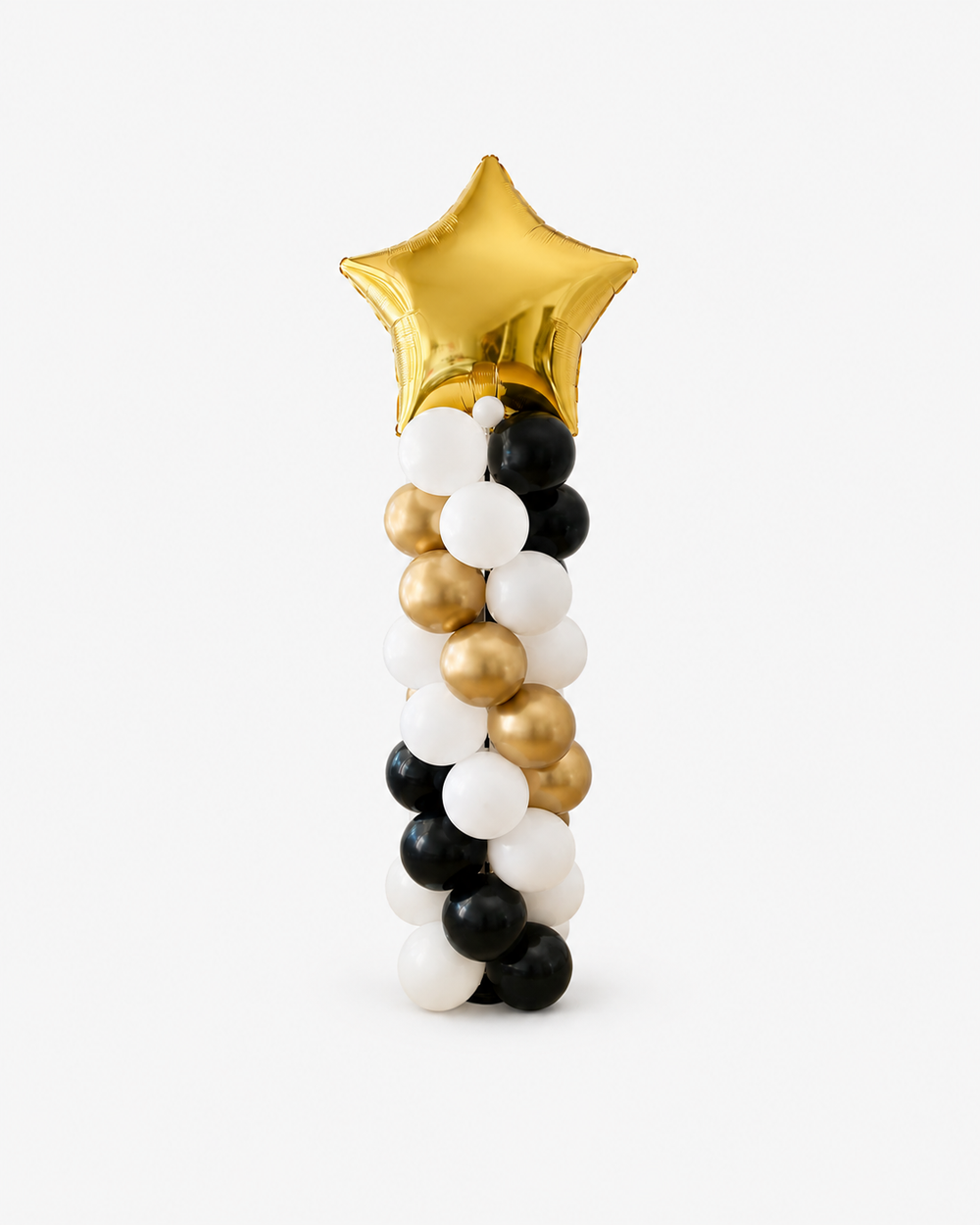 A graduation-themed balloon decoration featuring a metallic gold star balloon  and a twisted column of black, white, and gold balloons below, set against a plain light gray background.