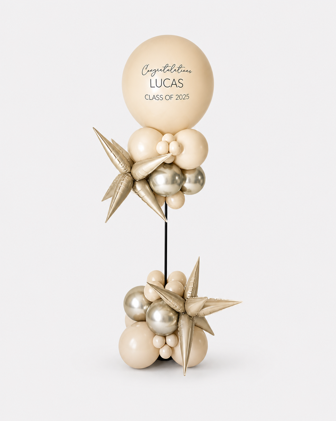 balloon column with beige jumbo balloon on top and star-shaped accents
