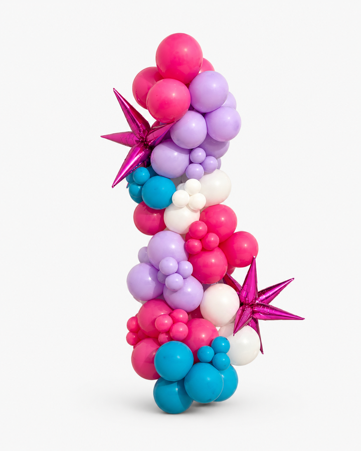 Hot pink, lilac, white, and turquoise balloon garland with star-shaped foil accents