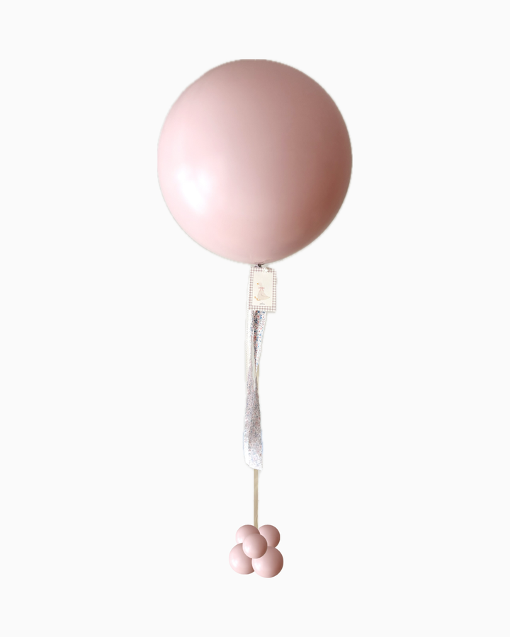 Pink jumbo balloon showing full height and mini balloon weight