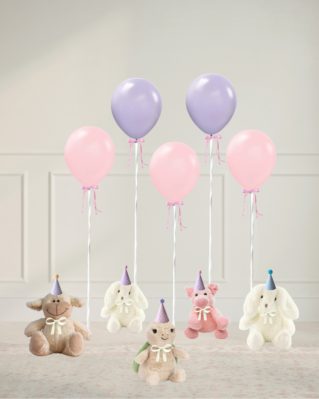 pink and lilac balloons tied to stuffed animals with party hats sitting on the floor in a room