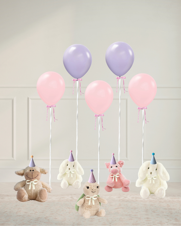 pink and lilac balloons tied to stuffed animals with party hats sitting on the floor in a room
