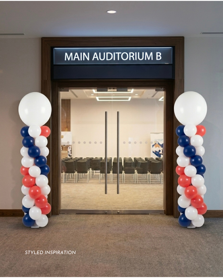 Mockup image of a decorative balloon columns in front of a main auditorium door with &
