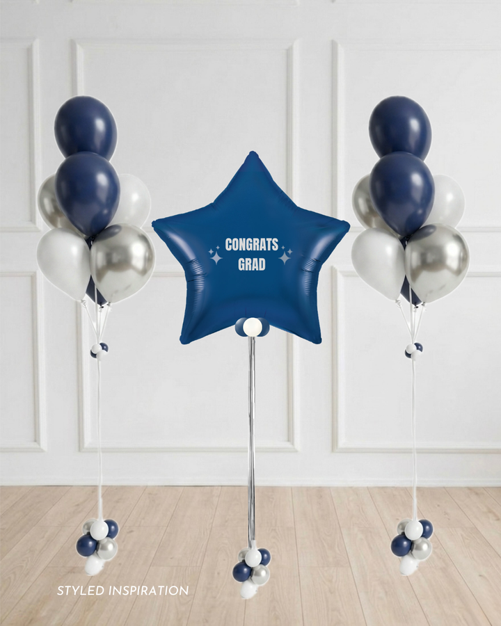 navy star balloon with  text "Congrats Grad" surrounded by balloon bouquets in navy blue, white, and silver.