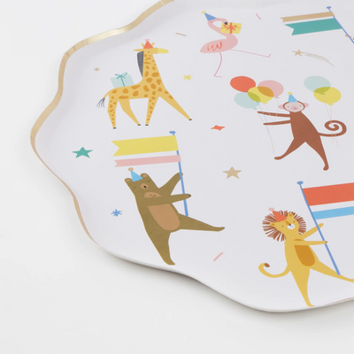 close up of round paper plates with animals wearing party hats and holding flags and balloons for Animal Parade Party