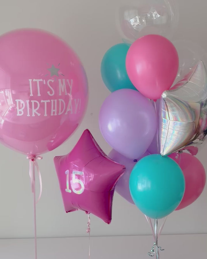 video of balloon set showing Jumbo balloon with custom text, star balloon with age decal, helium bouquet with iridescent star and bubble balloons